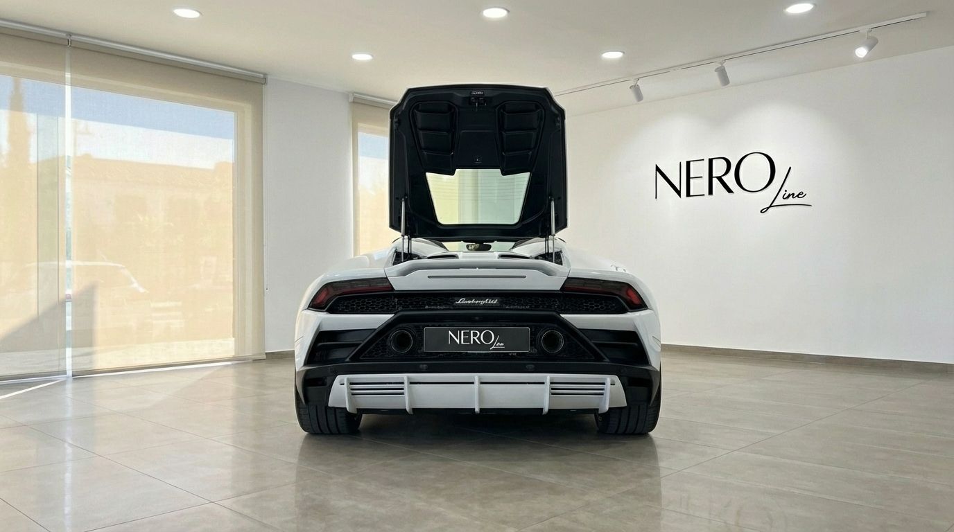 The rear view of the white Lamborghini Huracan Evo Spyder in Alicante, showcasing its open engine bay and distinctive exhaust.