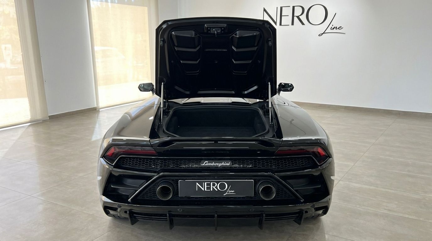 The black Lamborghini Huracan Evo Spyder's rear view in Alicante, showcasing its open front trunk and sporty exhaust.