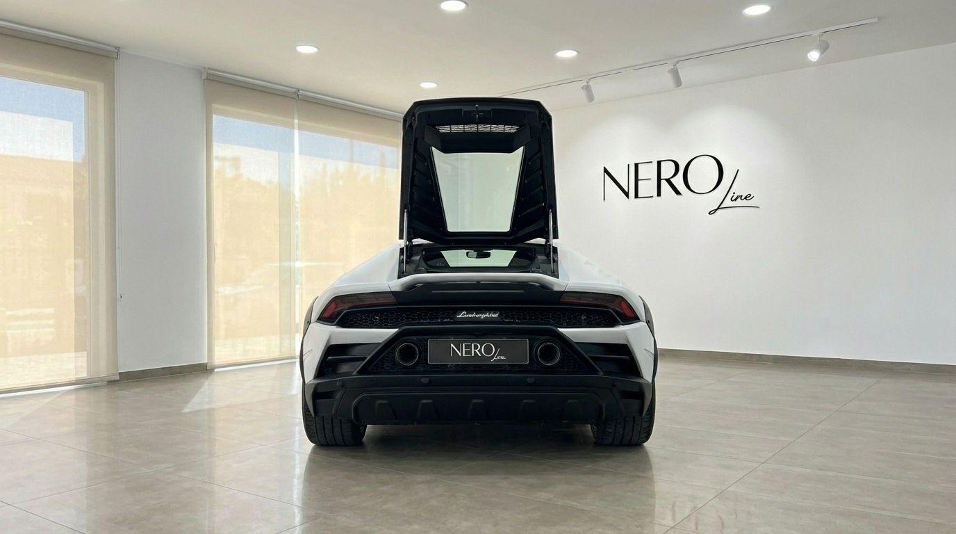 The white Lamborghini Huracán Sterrato 2024 is shown from the rear with its engine bay open in a showroom in Madrid.