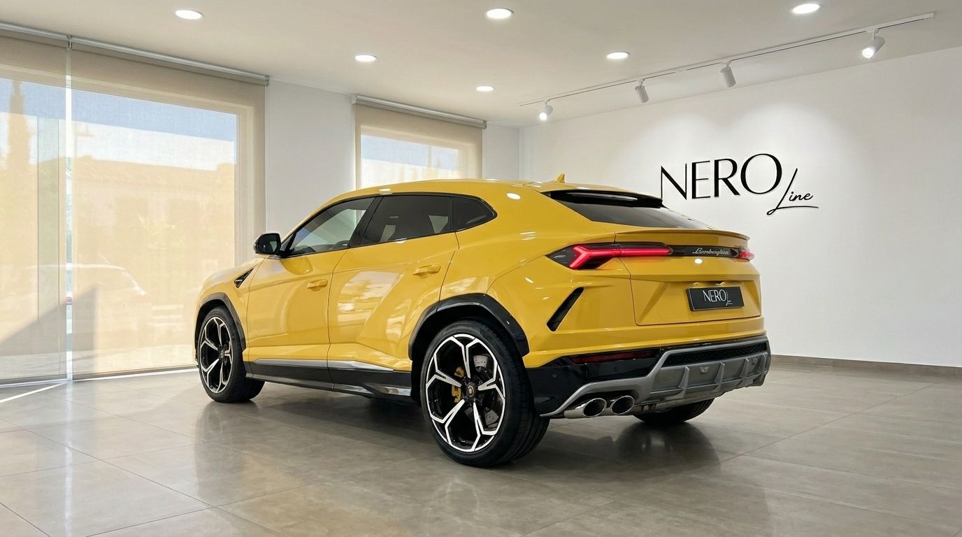 The yellow 2020 Lamborghini Urus is showcased from a rear three-quarter angle in a bright showroom in Marbella.