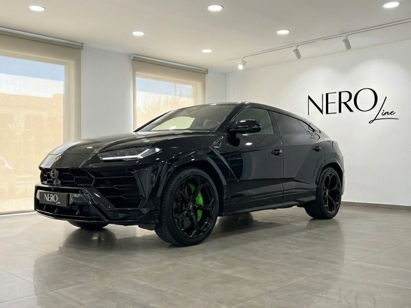 Lamborghini Urus — Black with Green Calipers A sleek black Lamborghini Urus with vibrant green brake calipers, captured in a showroom, front three-quarter view, in Barcelona.