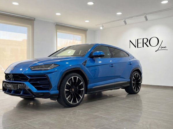 Lamborghini Urus — Metallic Blue SUV in Mallorca A metallic blue Lamborghini Urus is parked indoors, viewed from the front three-quarter angle in Mallorca.