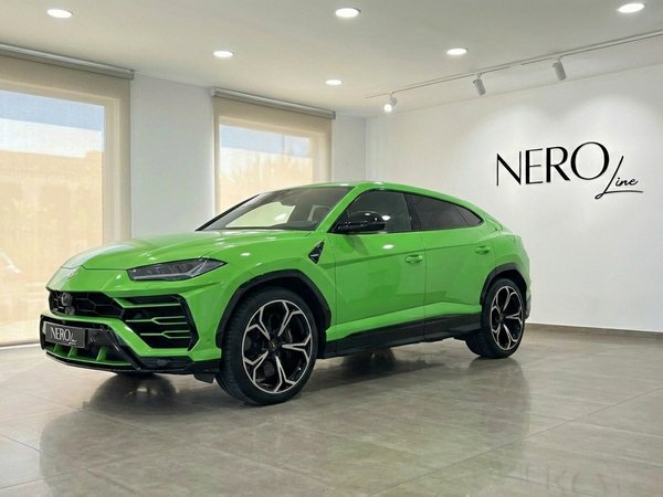 Lamborghini Urus S — Neon Green SUV in Marbella The neon green 2024 Lamborghini Urus S, a luxury performance SUV, is showcased in a showroom in Marbella.