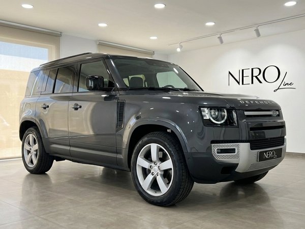 Land Rover Defender 3.0 — Front view Marbella The dark grey 2022 Land Rover Defender 3.0 is showcased from a front three-quarter view in a Marbella showroom.
