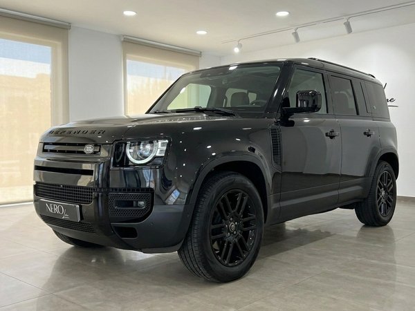 Land Rover Defender P400e — Showroom Ibiza The black Land Rover Defender P400e is showcased from a front three-quarter view in a bright showroom in Ibiza.