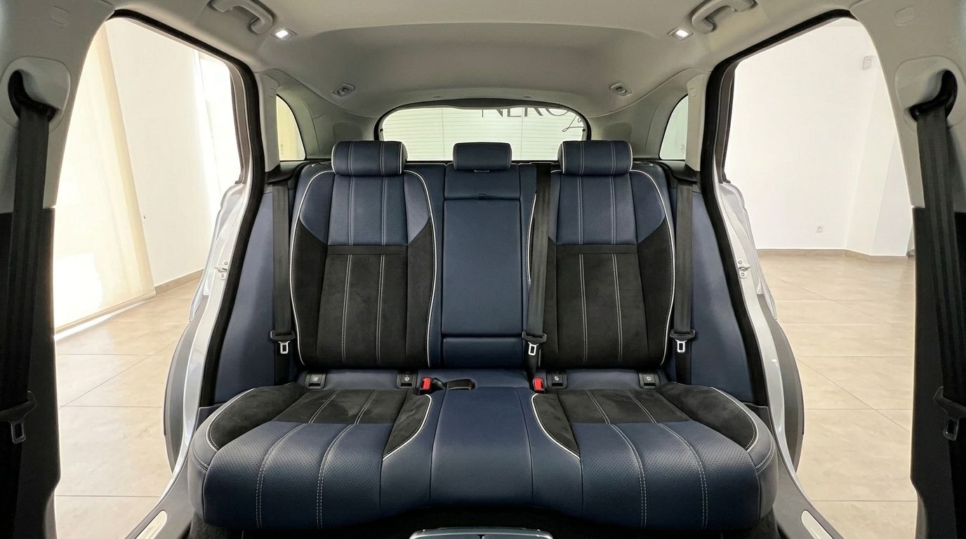 The image shows the blue and black leather rear seats of the Land Rover Range Rover Velar, highlighting the spacious interior in Alicante.