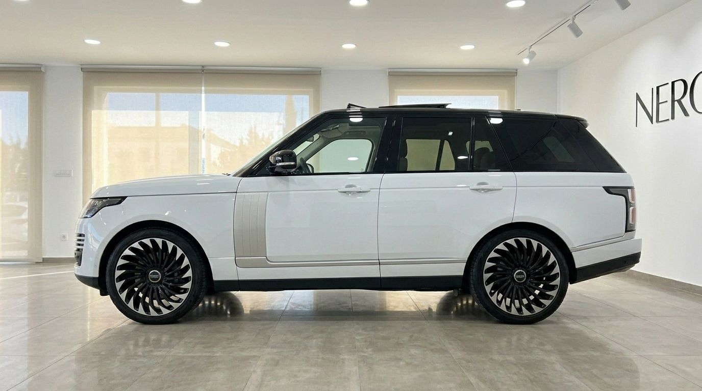 The white Land Rover Range Rover Vogue 2021 is shown in a side profile view inside a showroom in Alicante.
