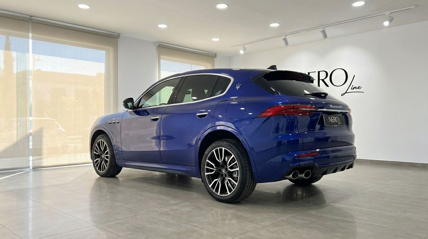 The metallic blue 2026 Maserati Grecale is showcased from a rear three-quarter view inside a showroom in Benidorm.