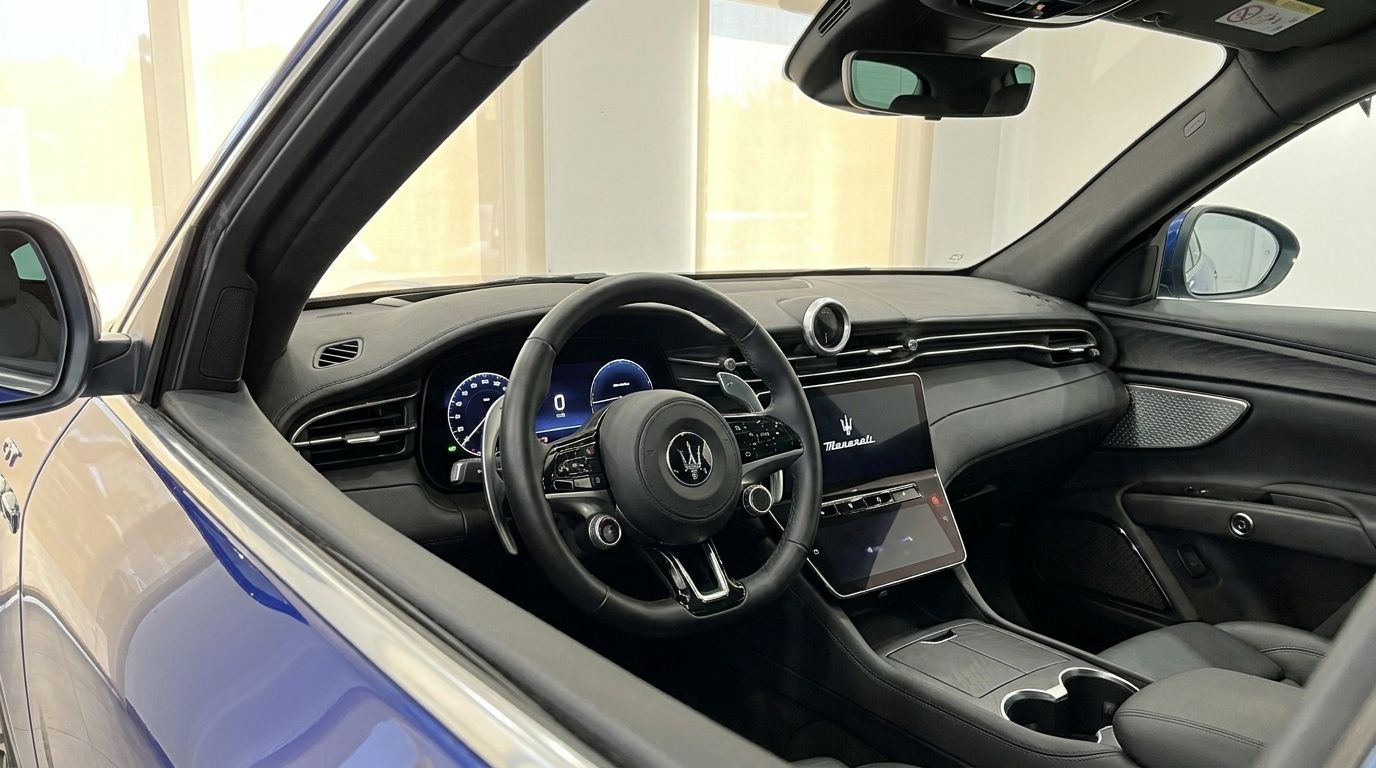 View of the luxurious Maserati Grecale interior in Benidorm, featuring its modern dashboard, steering wheel, and infotainment screen.