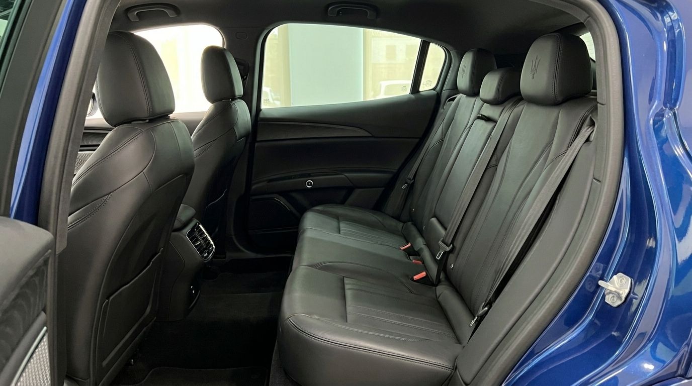 The luxurious black leather rear seats and interior of the metallic blue Maserati Grecale in Benidorm.