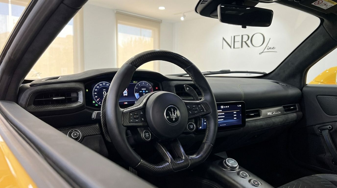 The image shows the luxurious interior cockpit of the Maserati MC20 in Valencia, featuring the steering wheel, dashboard, and digital displays.