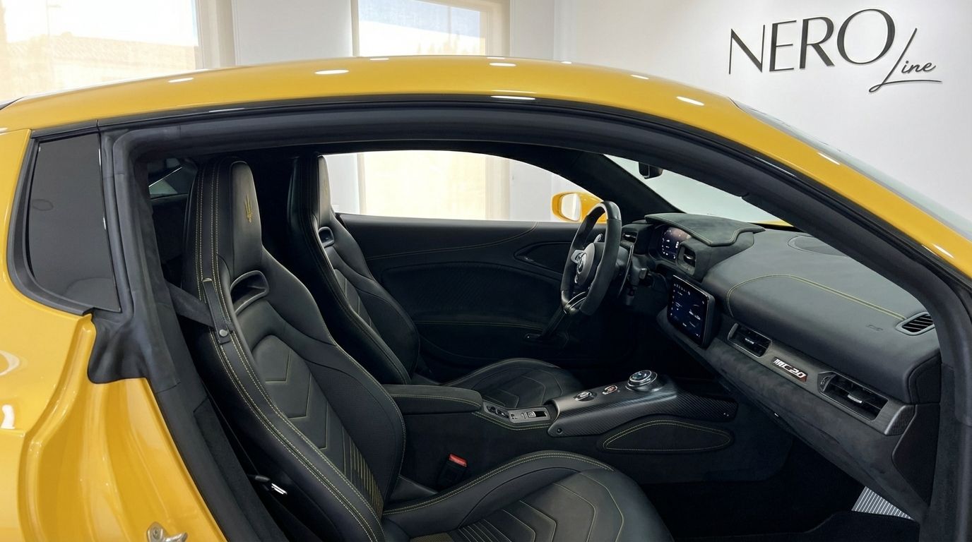 The Maserati MC20's luxurious interior features black leather sport seats with yellow stitching, a modern dashboard, and steering wheel in Valencia.