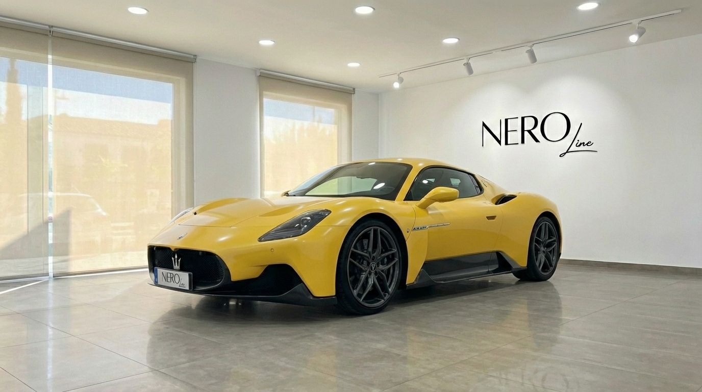 A vibrant yellow Maserati MC20 supercar is displayed from a front three-quarter angle inside a showroom in Valencia.