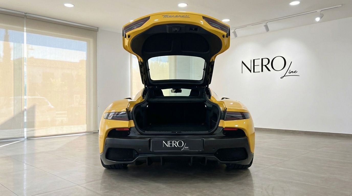 The yellow Maserati MC20's rear view shows its open trunk, revealing ample storage space in Valencia.