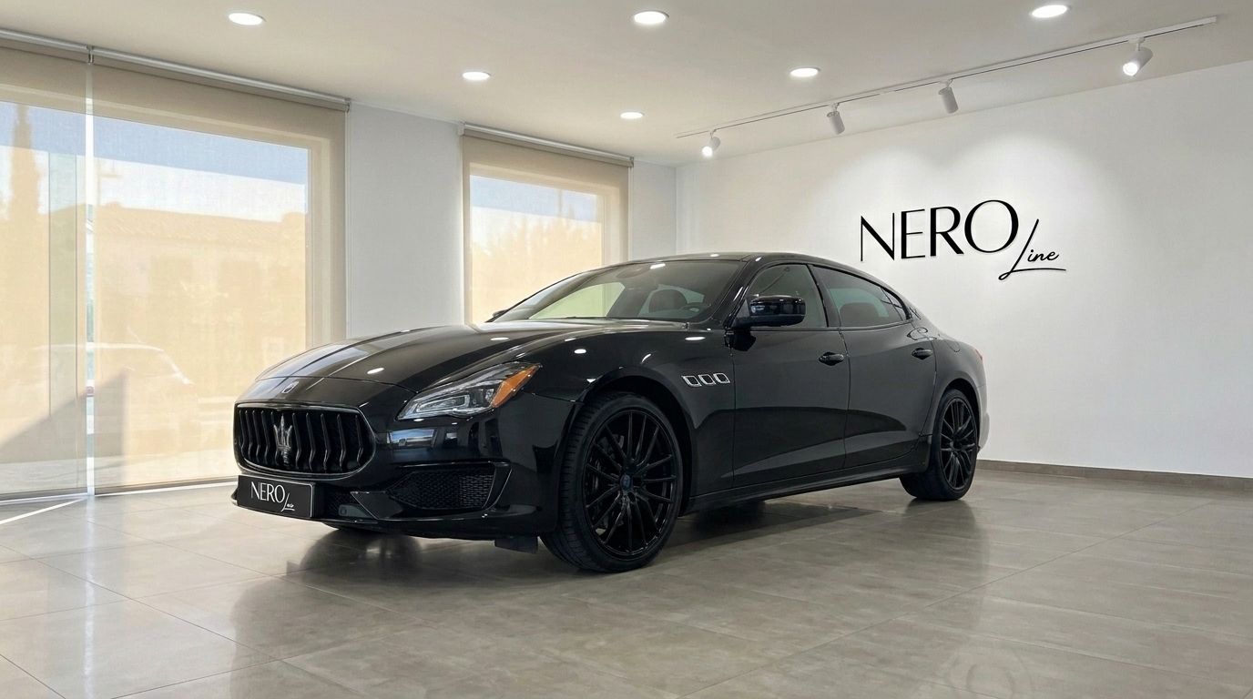 The black Maserati Quattroporte Sq4 Nerissimo is showcased in a front three-quarter view inside a showroom in Madrid.