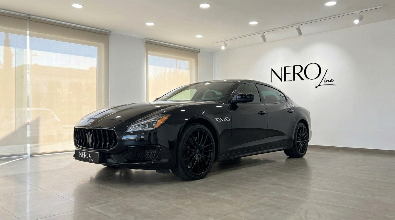 Maserati Quattroporte Sq4 Nerissimo — Showroom Madrid The black Maserati Quattroporte Sq4 Nerissimo is showcased in a front three-quarter view inside a showroom in Madrid.