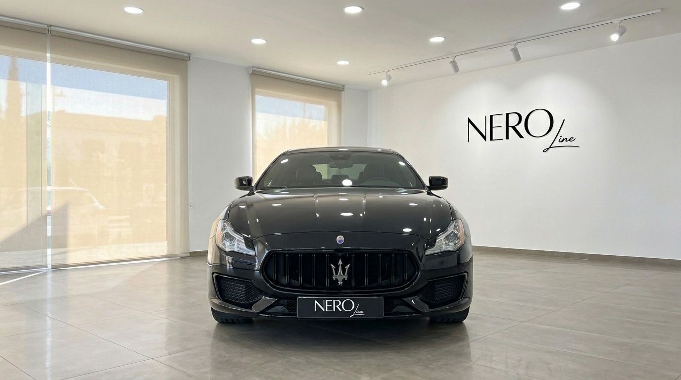The black Maserati Quattroporte Sq4 Nerissimo is shown from the front in a bright showroom in Madrid.