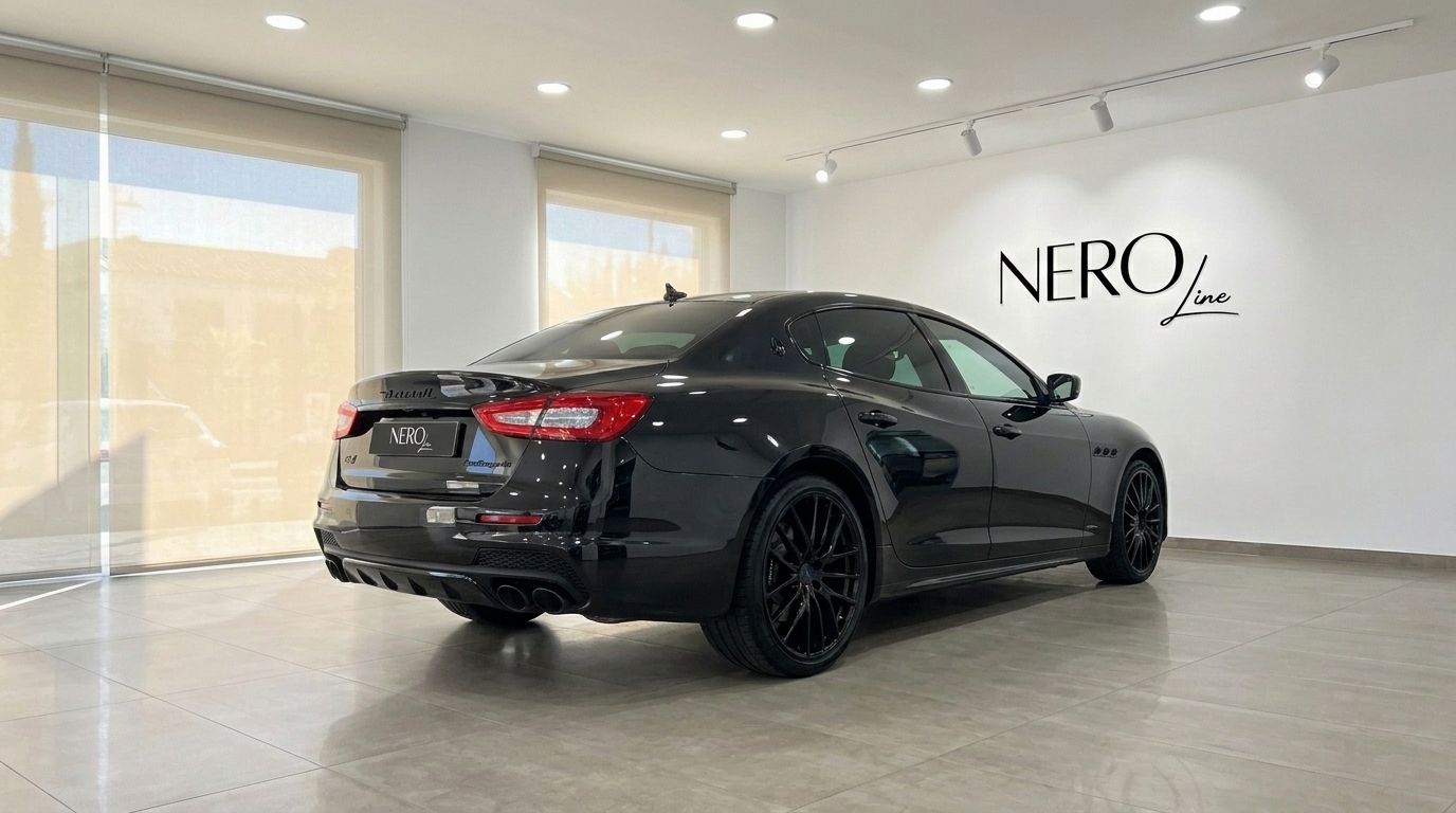 The black Maserati Quattroporte Sq4 Nerissimo is showcased from a rear three-quarter angle in a showroom in Madrid.