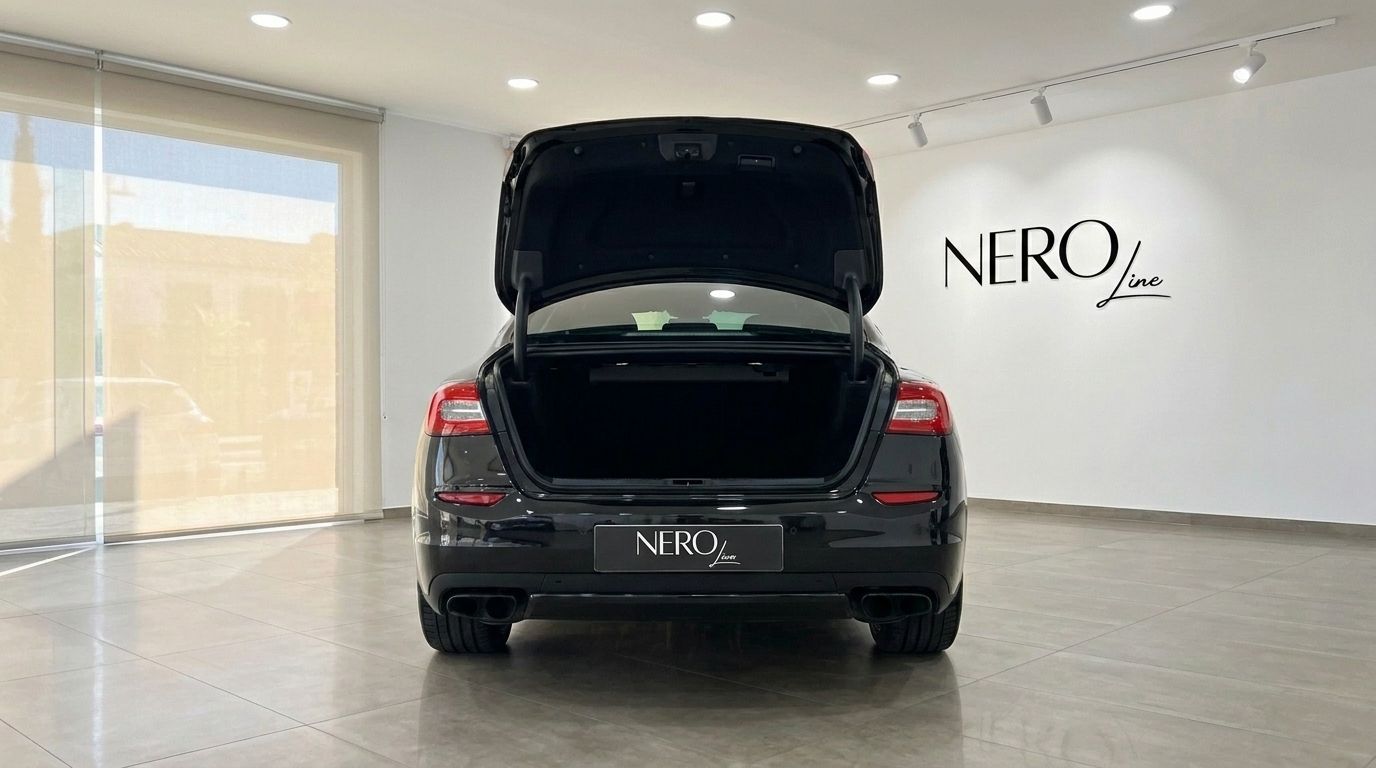 Rear view of the black Maserati Quattroporte Sq4 Nerissimo with its trunk open, showcasing ample storage in Madrid.