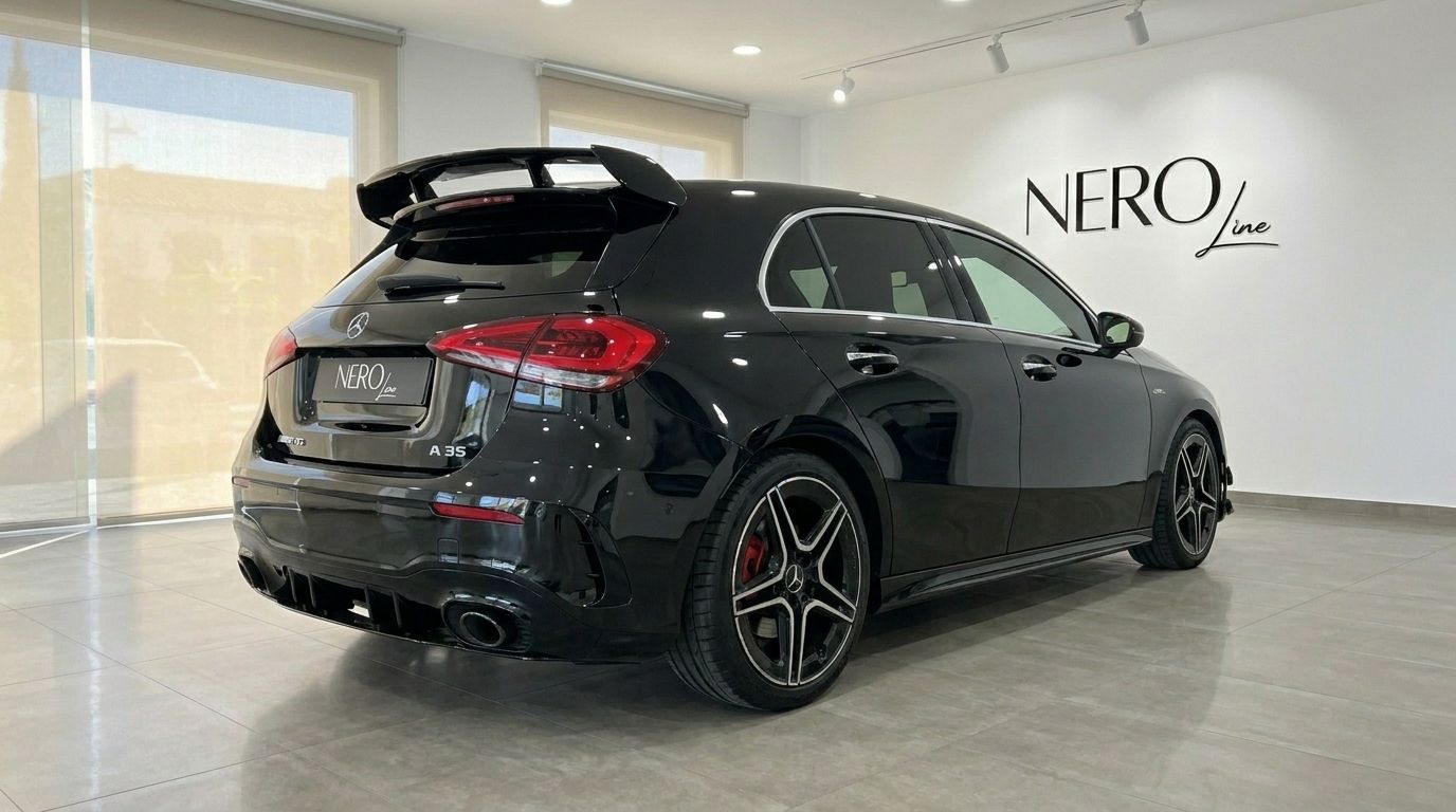 Der glänzend schwarze Mercedes-Benz A 35 AMG von 2022 ist aus einer hinteren Dreiviertelansicht in einem Showroom in Alicante zu sehen.