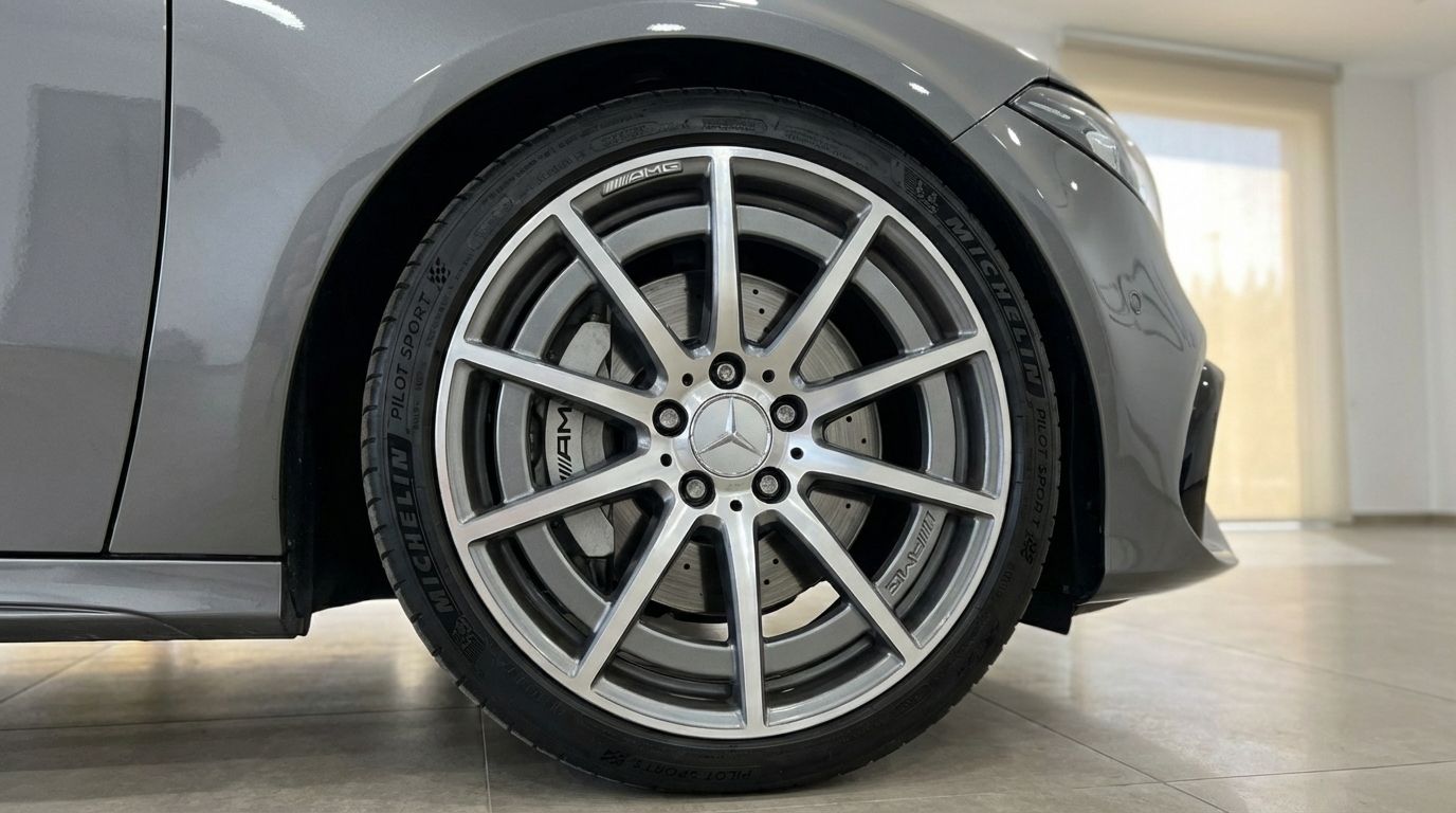 A close-up view of the metallic grey Mercedes-Benz A 45 AMG's front wheel and fender in Alicante.