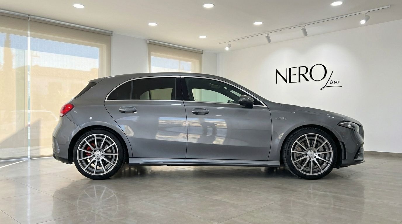 The metallic grey 2022 Mercedes-Benz A 45 AMG is showcased in a side profile view within a showroom in Alicante.