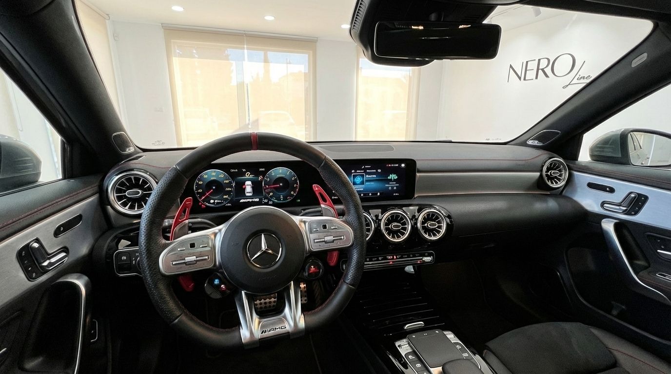 The Mercedes-Benz A35 AMG Limousine cockpit in Alicante, featuring the steering wheel, digital displays, and dashboard with red accents.