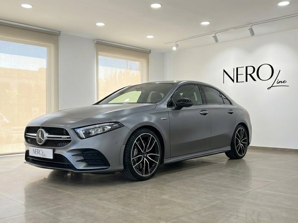 Mercedes-Benz A35 AMG Limousine — Showroom Alicante The matte grey Mercedes-Benz A35 AMG Limousine is showcased from a front three-quarter angle in a modern showroom in Alicante.
