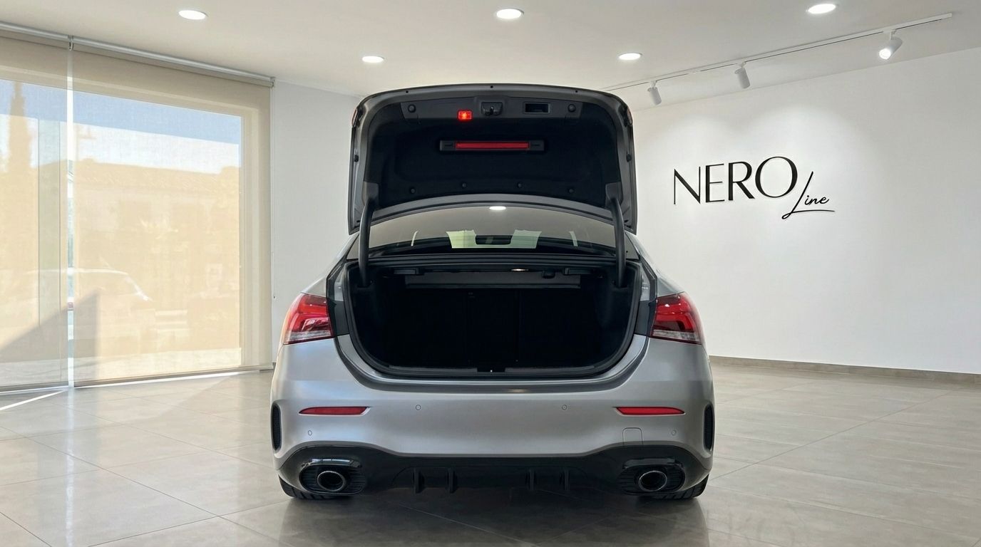 Rear view of the matte grey Mercedes-Benz A35 AMG Limousine with its trunk open, showcasing storage space in Alicante.