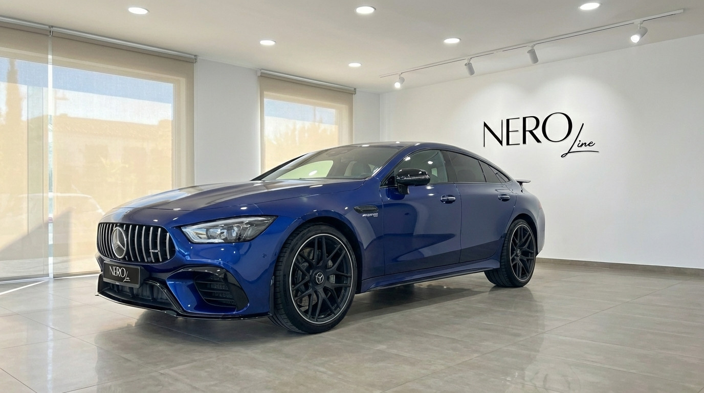 Mercedes-Benz AMG GT 4-Door Coupe — Luxury Sedan A striking blue Mercedes-Benz AMG GT 4-Door Coupe is showcased from a front three-quarter angle inside a showroom in Alicante.