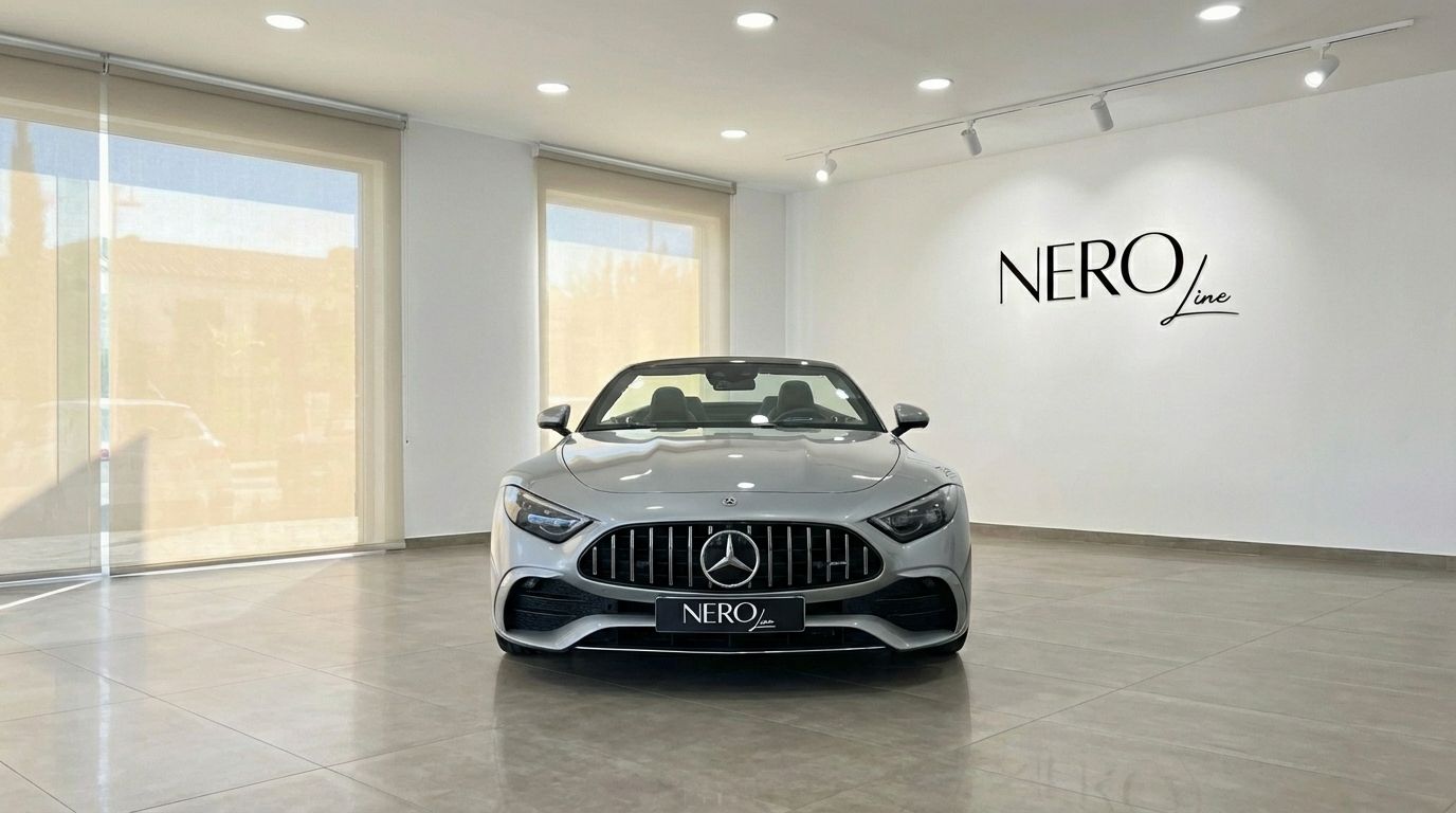 The silver grey Mercedes-Benz AMG GT Roadster is showcased from the front with its convertible top down in an Ibiza showroom.