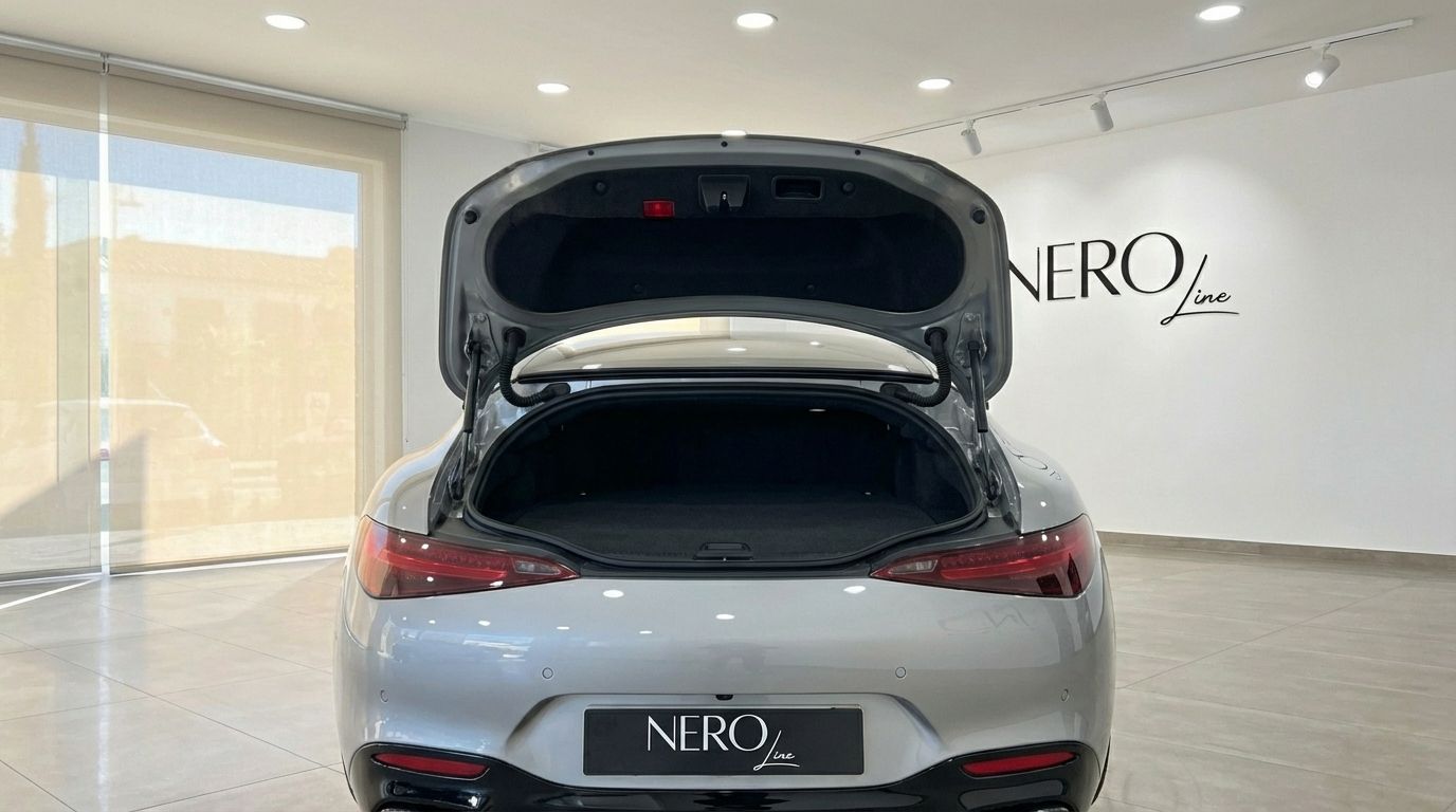 The Silver Grey Metallic Mercedes-Benz AMG GT Roadster is shown from the rear with its trunk open, in a showroom in Ibiza.