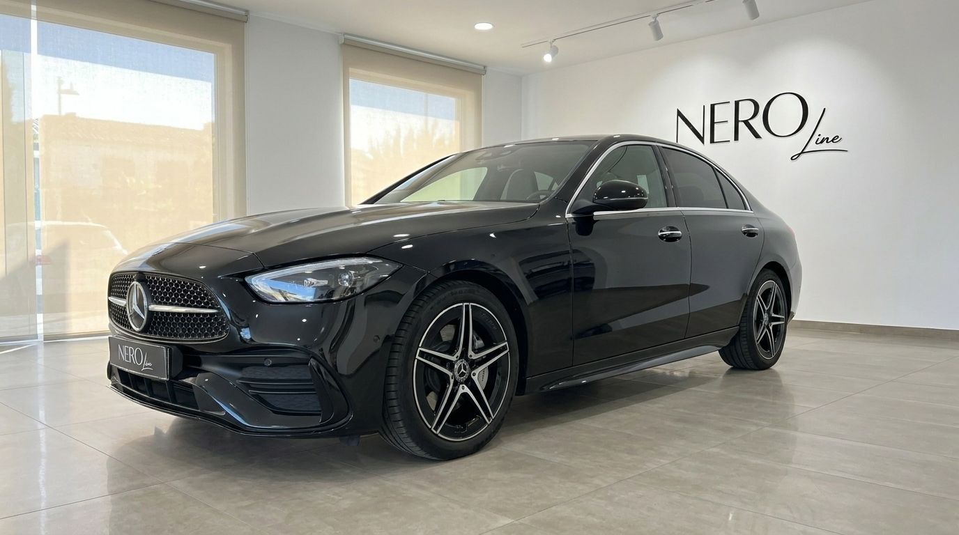The sleek black Mercedes-Benz C 180 sedan is presented from a front three-quarter view inside a showroom in Alicante.