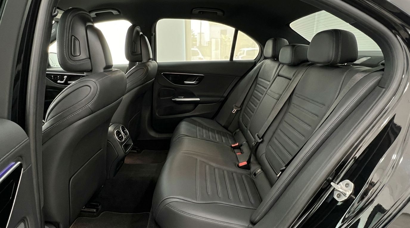 The luxurious black leather rear seats and door panel of the 2025 Mercedes-Benz C 180 in Alicante.