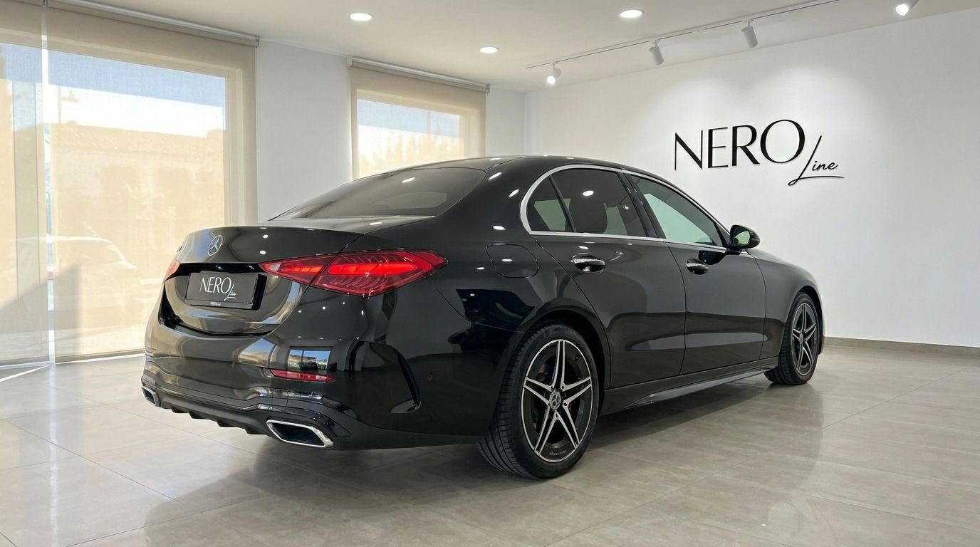 A sleek black Mercedes-Benz C 180 is parked at a rear three-quarter angle in a showroom in Alicante.