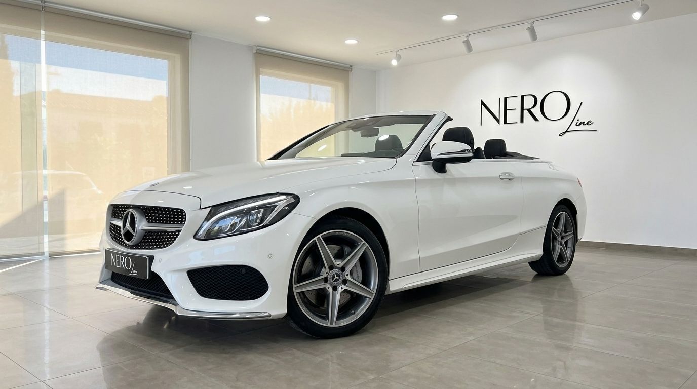 The white Mercedes-Benz C 200 Cabriolet convertible is showcased from a front three-quarter angle in a bright Alicante showroom.