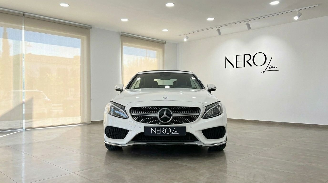 The white Mercedes-Benz C 200 Cabriolet is prominently displayed from the front in a showroom in Alicante.