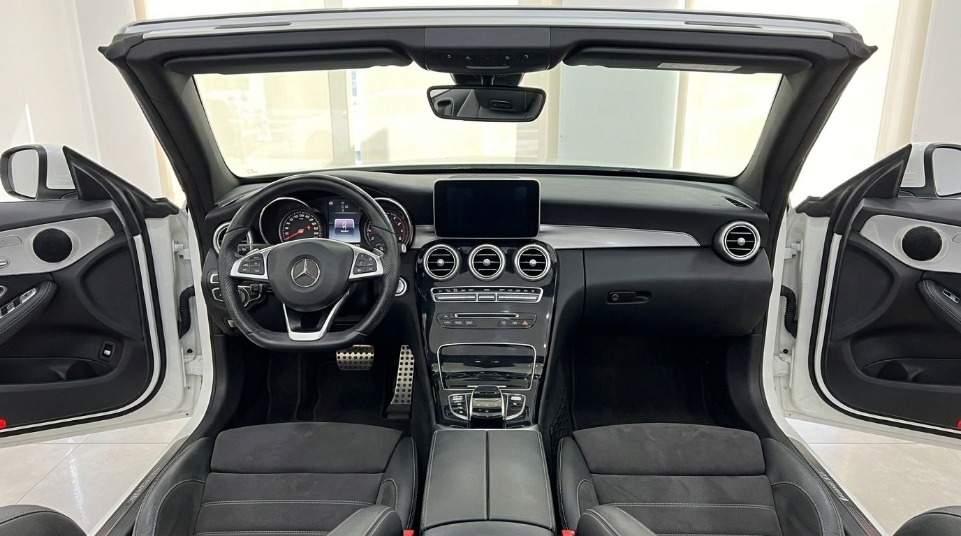 The luxurious interior and cockpit of the Mercedes-Benz C 200 Cabriolet, featuring the dashboard, steering wheel, and seats in Alicante.