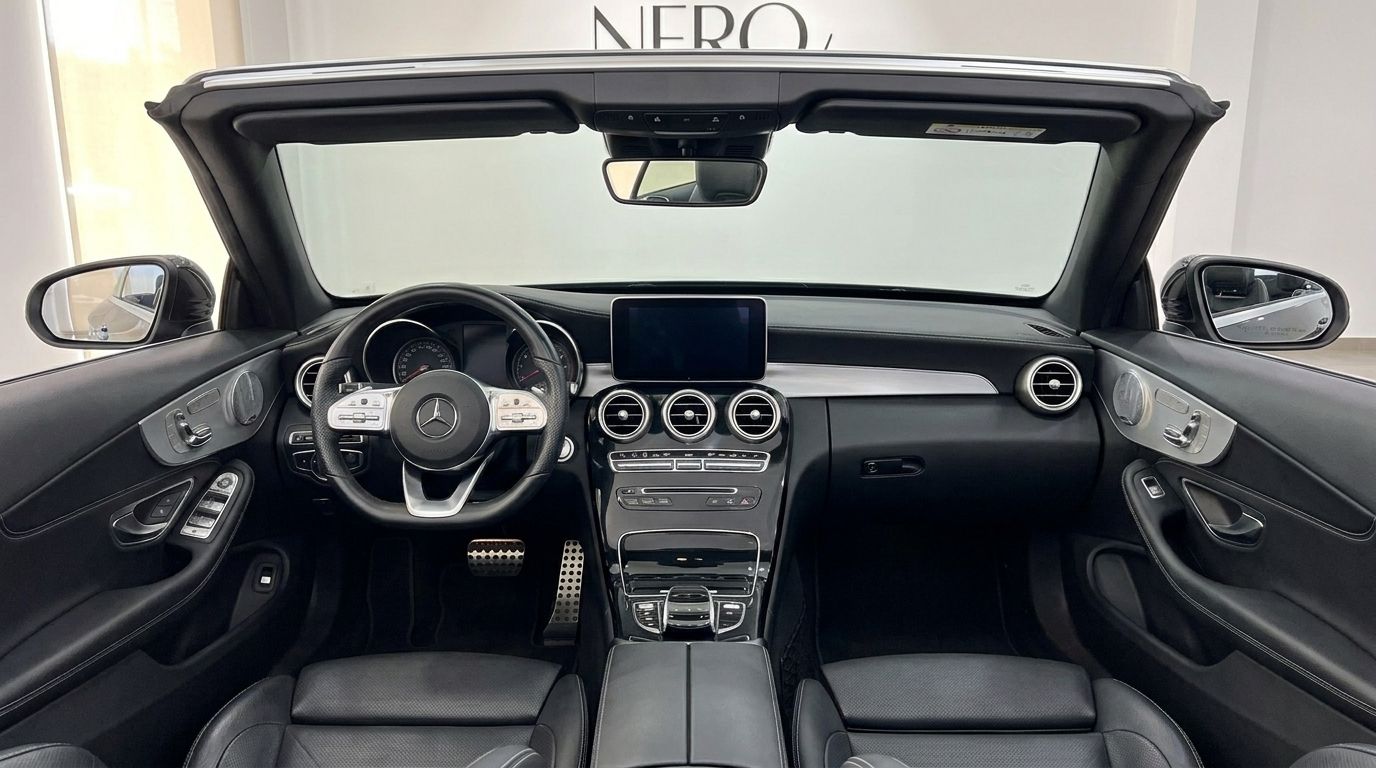 The luxurious black leather interior and modern dashboard of the Mercedes-Benz C-Class Cabriolet in Alicante.