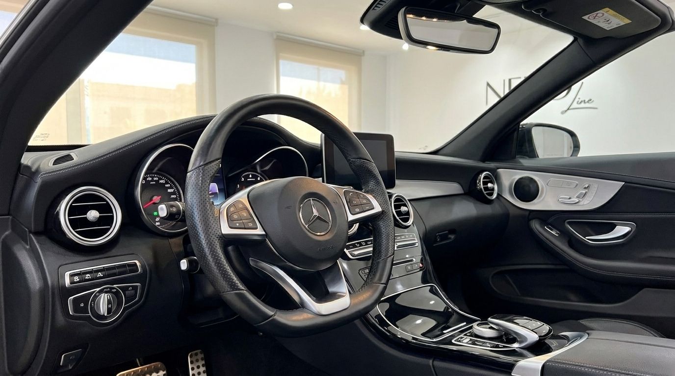 The luxurious interior of the Mercedes-Benz C-Class Cabriolet in Alicante, featuring the steering wheel and dashboard.