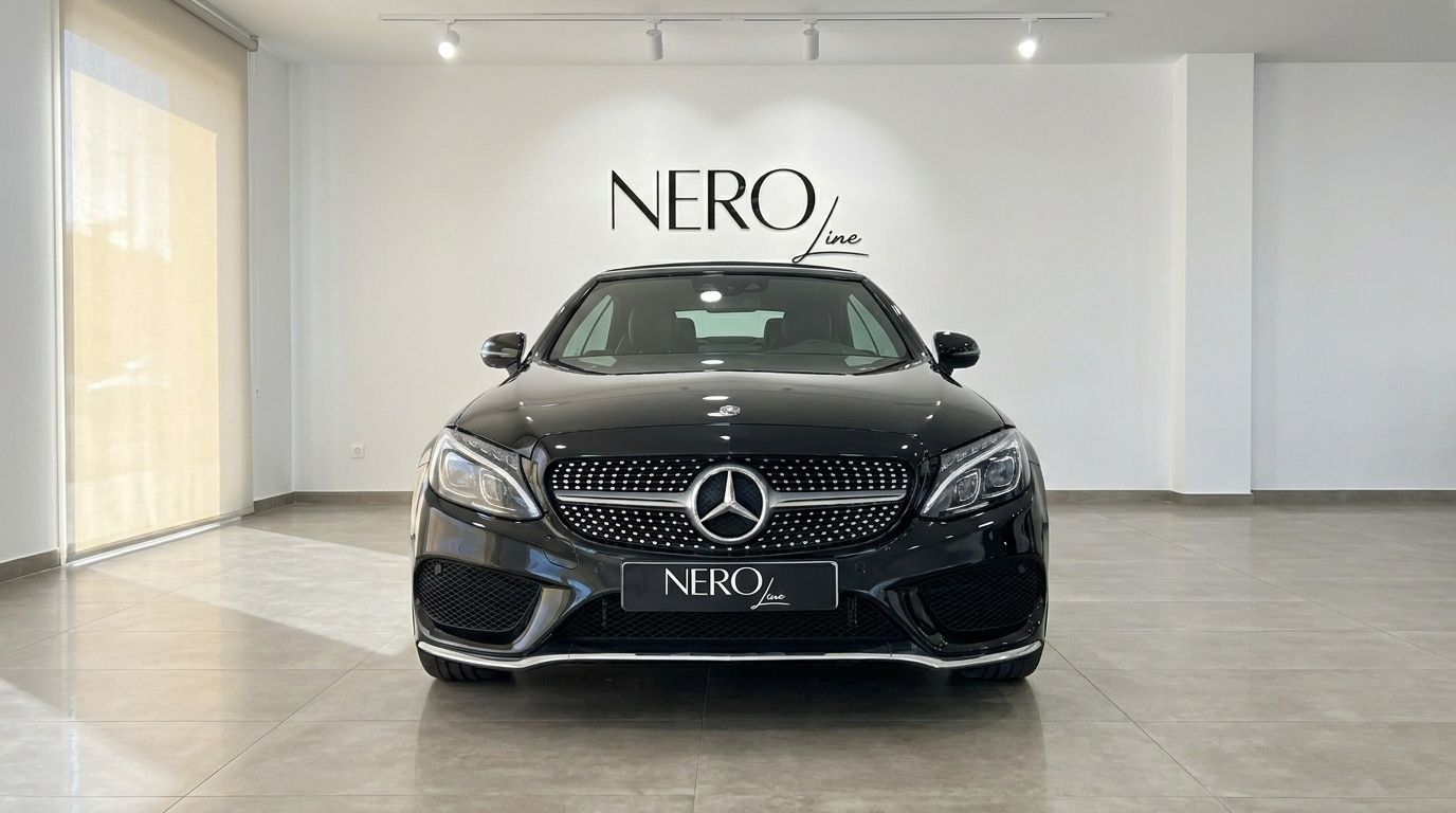 The sleek black Mercedes-Benz C-Class Cabriolet is showcased from the front in a bright Alicante showroom.