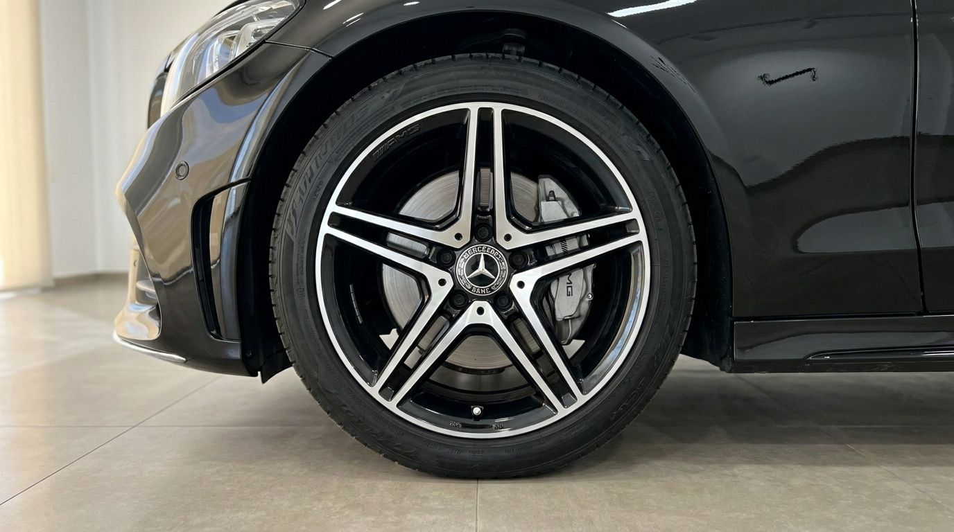 Close-up of the Mercedes-Benz C-Class Cabriolet's black AMG alloy front wheel and brake caliper in Alicante.