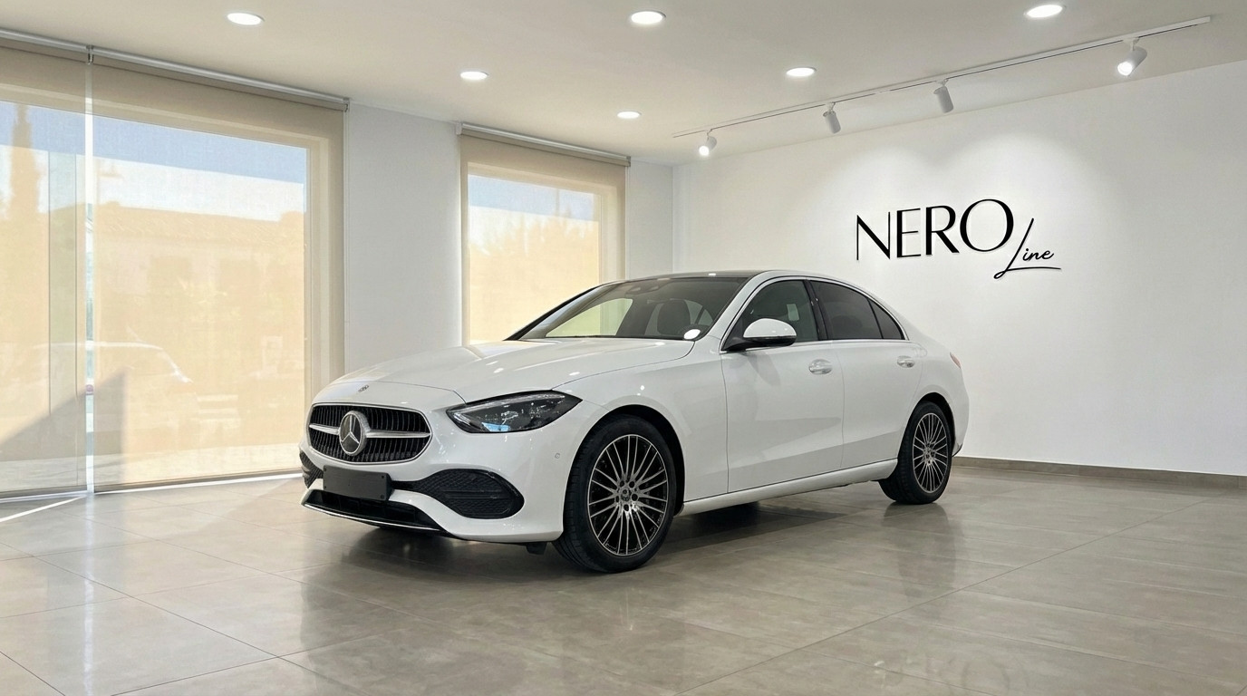 Mercedes-Benz C220d — Luxury sedan in Alicante White Mercedes-Benz C220d luxury sedan displayed at a front three-quarter angle in a showroom in Alicante.