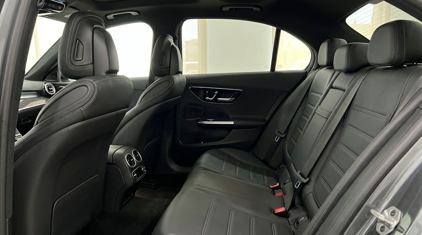 View of the Mercedes-Benz C63 AMG's luxurious dark grey leather rear seats and door panel in Alicante.