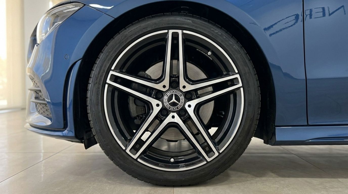 The Mercedes-Benz CLA in Gloss Metallic Blue, showcasing its distinctive front wheel with a black and silver multi-spoke rim in Mallorca.