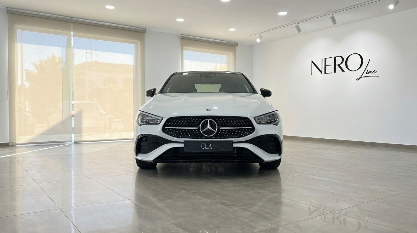 The white Mercedes-Benz CLA 200 is prominently displayed from a front view in a bright showroom in Alicante.