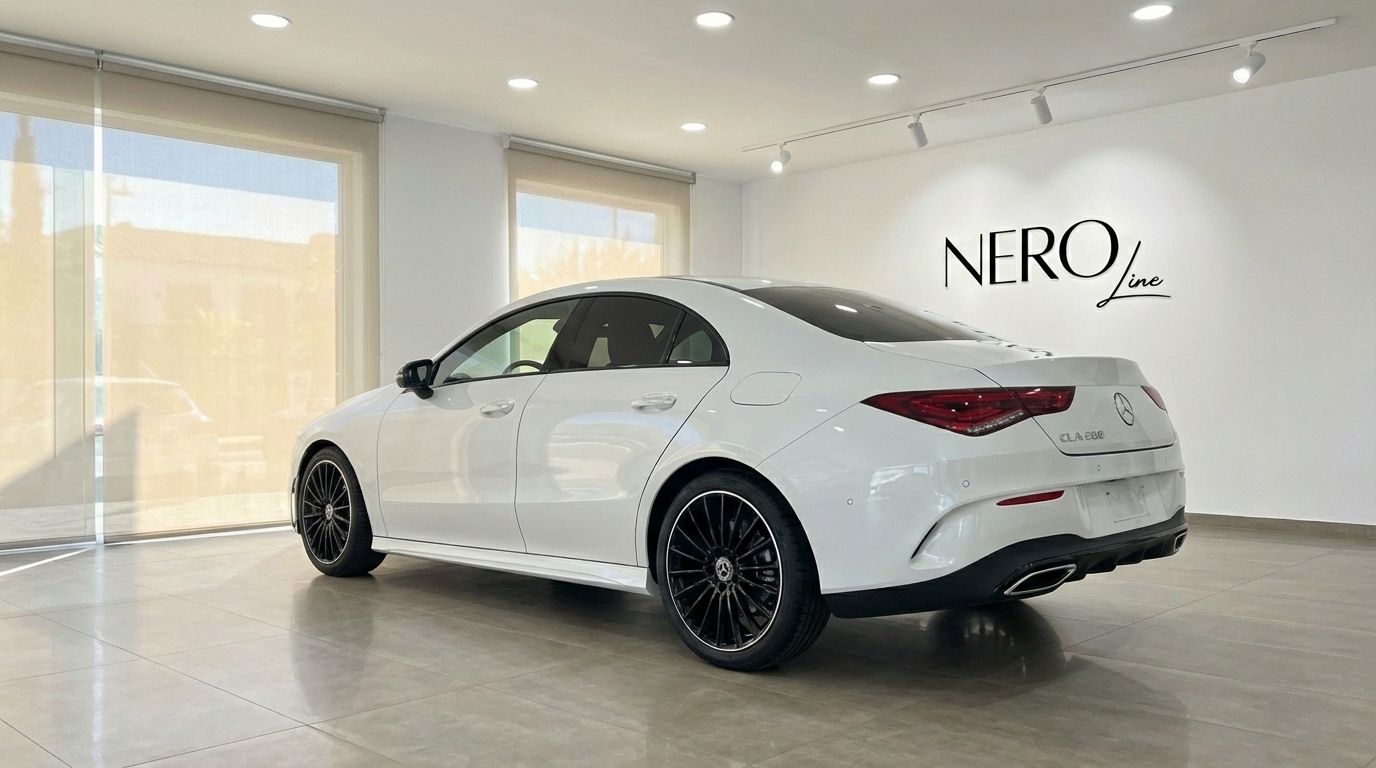 The white Mercedes-Benz CLA 200 is shown in a rear three-quarter view, parked indoors at the NeroLine showroom in Alicante.