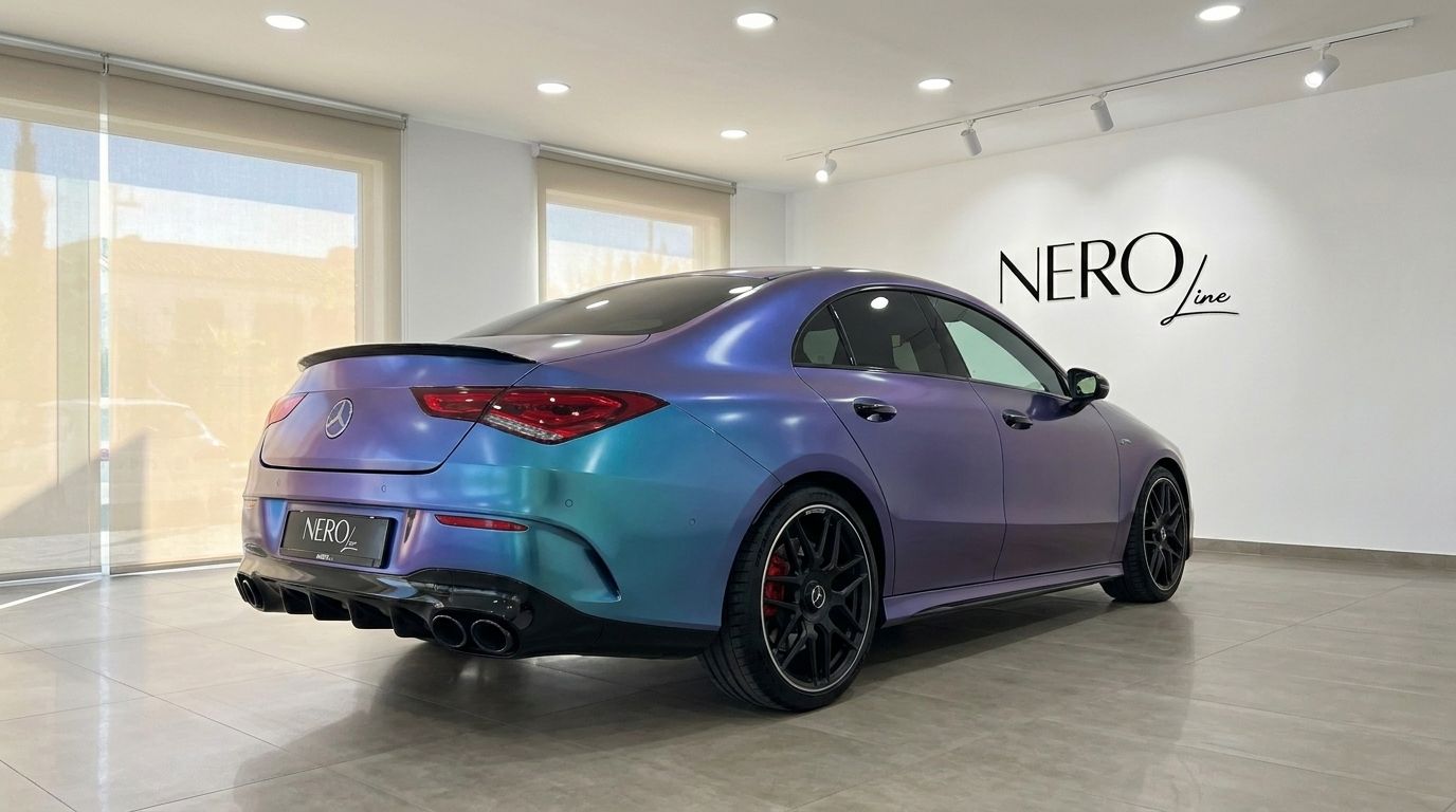 The Mercedes-Benz CLA 45 AMG in Alicante showcases its unique chameleon wrap from a rear three-quarter view.