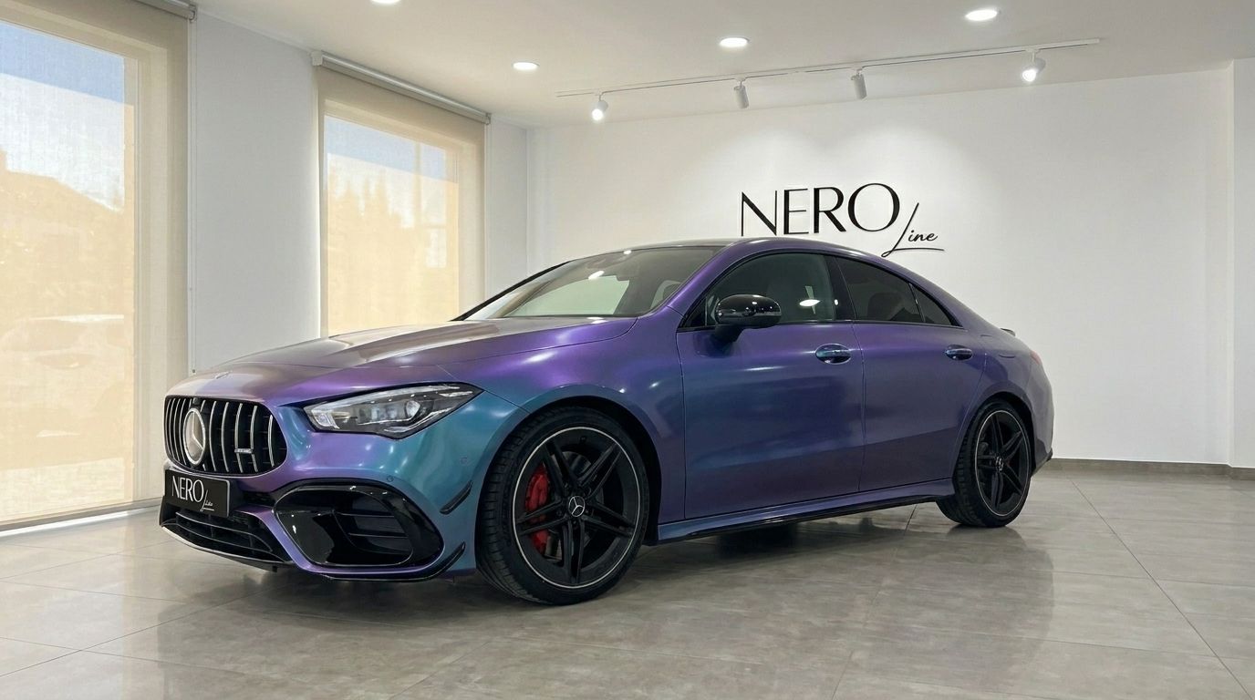 The Mercedes-Benz CLA 45 AMG, showcasing its striking iridescent purple-blue finish, is parked in a showroom in Alicante.