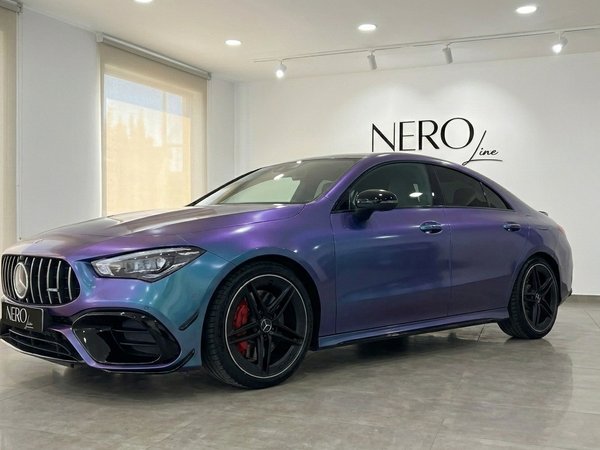 Mercedes-Benz CLA 45 AMG — Iridescent luxury The Mercedes-Benz CLA 45 AMG, showcasing its striking iridescent purple-blue finish, is parked in a showroom in Alicante.